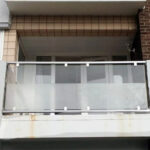 Metal balcony on veranda with glass balustrade